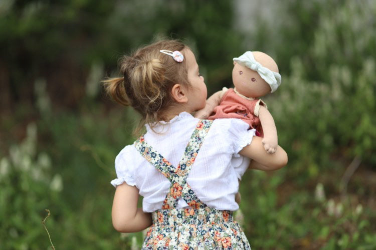 Little girl playing with Baby Aria.