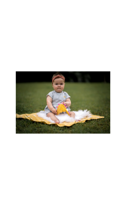 Baby playing with the stegosaurus crinkle toy