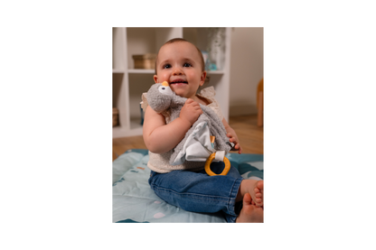 Baby playing with Martin the comforter