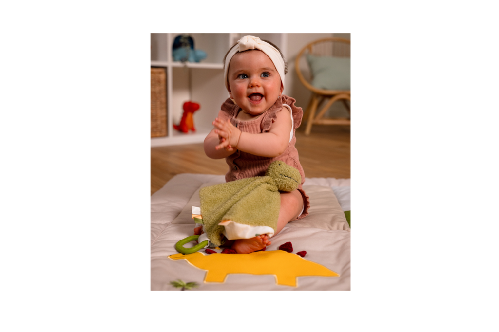Baby playing with Rex the Tyrannosaurus.