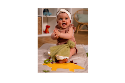 Baby playing with Rex the Tyrannosaurus.