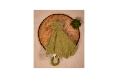 Rex the Tyrannosaurus displayed on a brown handwoven tray with a green flower on it 