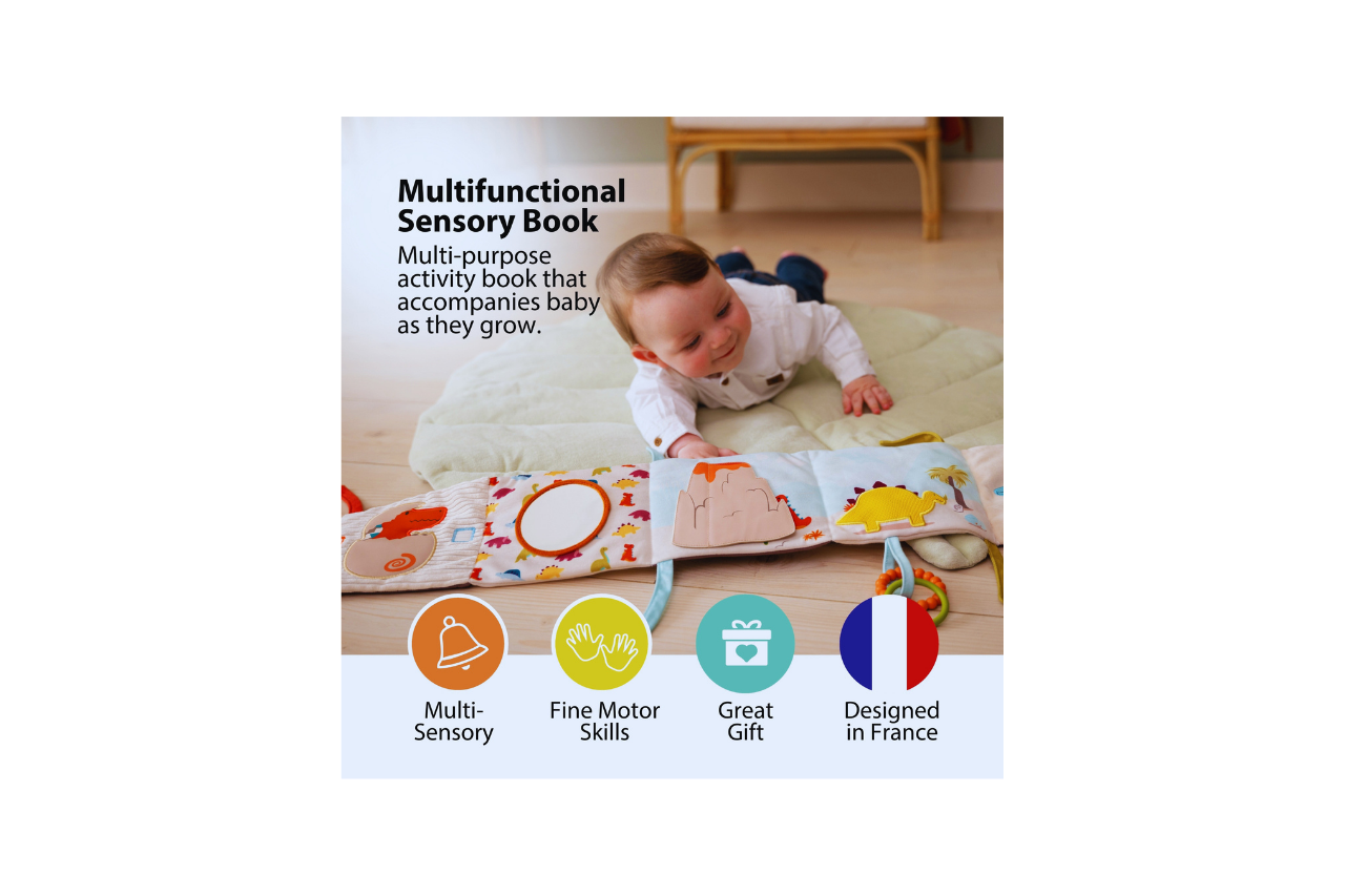 Baby laying on his tummy and checking out the Dino Soft Activity Book
