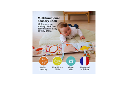 Baby laying on his tummy and checking out the Dino Soft Activity Book