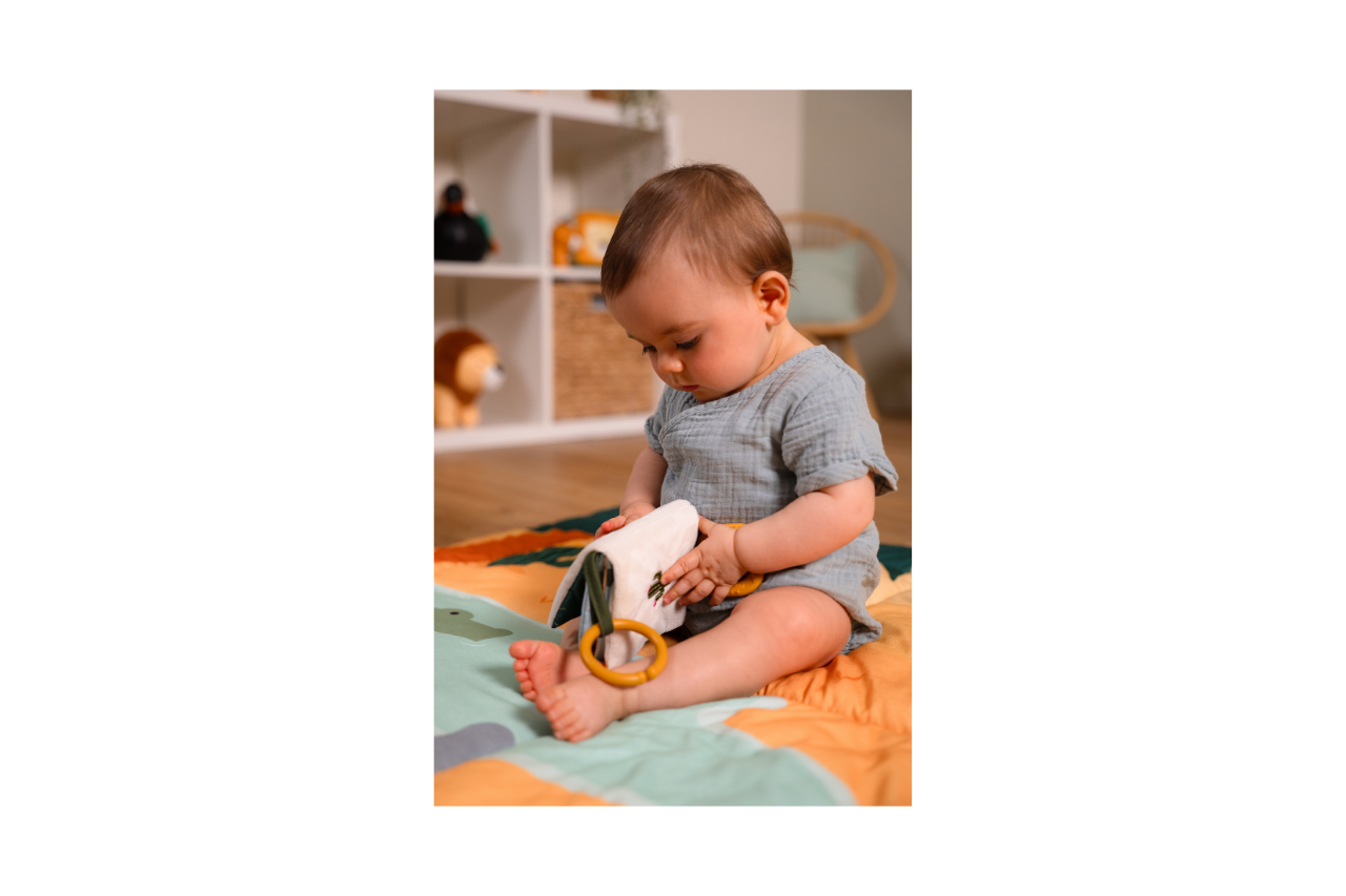 Baby holding and  looking at the Jungle book