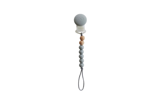 Tiny Teethers mini pacifier clip is perfect for the mini in your life. This innovative silicone clip is designed with a few moving parts and no metals. This allows your baby to teethe on the clip itself unlike the metal ones. Designed with fewer medium weight beads, our pacifier clip won't pull the soother out of your little baby's mouth. It will also stay clipped to your baby's clothing, preventing you from losing the soother or having it fall to the ground and get dirty in the moment you need it most.