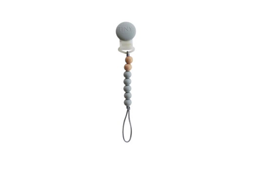 Tiny Teethers mini pacifier clip is perfect for the mini in your life. This innovative silicone clip is designed with a few moving parts and no metals. This allows your baby to teethe on the clip itself unlike the metal ones. Designed with fewer medium weight beads, our pacifier clip won't pull the soother out of your little baby's mouth. It will also stay clipped to your baby's clothing, preventing you from losing the soother or having it fall to the ground and get dirty in the moment you need it most.