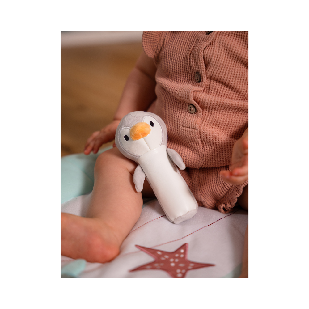 Martin the Penguin resting on baby's leg