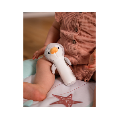 Martin the Penguin resting on baby's leg