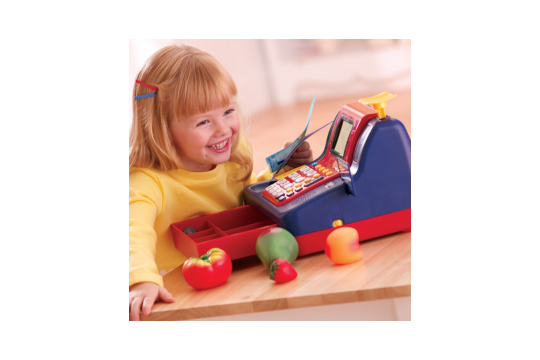 A little girl is pictured playing with the pretend cash register.