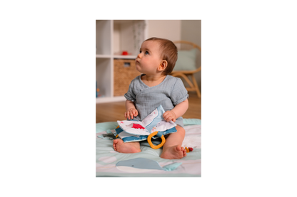 Baby holding open the Soft Baby Book - Ocean 