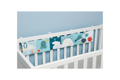 Ocean Soft Activity Book displayed on a crib/strung across the crib slats